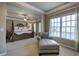A well-lit main bedroom featuring a decorative four poster bed and a comfy chaise lounge at 636 Parkside Village Nw Way, Marietta, GA 30060