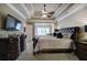 Primary bedroom featuring a tray ceiling, ceiling fan, and decorative furniture at 636 Parkside Village Nw Way, Marietta, GA 30060
