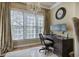 Bright home office featuring a large window, chandelier, and classic dark wood desk at 636 Parkside Village Nw Way, Marietta, GA 30060