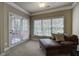 Comfortable sitting room featuring a leather sofa, large windows, and access to an outdoor balcony at 636 Parkside Village Nw Way, Marietta, GA 30060