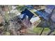 An aerial view of a two-story home boasting stone landscaping, a screened porch and a new roof at 6460 Pine Ridge Cir, Cumming, GA 30041