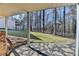 Backyard patio area showcasing a lawn with gravel walkway, forest background, and brick accent at 6460 Pine Ridge Cir, Cumming, GA 30041