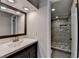 This bathroom has a large vanity with quartz countertops and a tile shower with recessed shelving at 6460 Pine Ridge Cir, Cumming, GA 30041