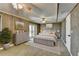 Spacious bedroom with wood paneling, king-size bed, and access to outdoor balcony at 6460 Pine Ridge Cir, Cumming, GA 30041