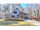 Charming two-story home with stone accents, arched entry, and well-manicured front lawn at 6460 Pine Ridge Cir, Cumming, GA 30041