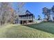 Back exterior of home featuring a screened-in porch, wooden deck, and a grassy yard at 6460 Pine Ridge Cir, Cumming, GA 30041