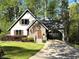 Charming two-story home with stone accents, arched entry, and well-manicured front lawn at 6460 Pine Ridge Cir, Cumming, GA 30041