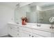 Bright bathroom featuring double vanity, large mirror, white cabinets, and a glass shower at 224 Gallant Fox Way, Acworth, GA 30102