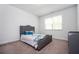 Cozy bedroom with a well-lit window and comfortable gray upholstered bed at 224 Gallant Fox Way, Acworth, GA 30102