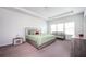 Large bedroom featuring a gray bed frame, a crib, and a window for natural light at 224 Gallant Fox Way, Acworth, GA 30102
