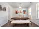 A modern dining room features hardwood floors, white walls, a wooden table, and wainscoting at 224 Gallant Fox Way, Acworth, GA 30102