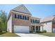 Charming two-story brick and siding home with a well-manicured lawn and an attached two-car garage at 224 Gallant Fox Way, Acworth, GA 30102