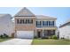 Charming two-story brick and siding home with a well-manicured lawn and an attached two-car garage at 224 Gallant Fox Way, Acworth, GA 30102