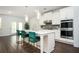 A modern kitchen features hardwood floors, white cabinets, stainless steel appliances and a center island at 224 Gallant Fox Way, Acworth, GA 30102
