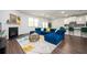 Open-concept living space with a blue sectional, fireplace, and view into kitchen at 224 Gallant Fox Way, Acworth, GA 30102