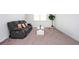 Comfortable living area features gray reclining sofa, modern coffee table, and natural light at 224 Gallant Fox Way, Acworth, GA 30102