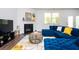 Bright living room featuring a fireplace and a comfortable blue sofa at 224 Gallant Fox Way, Acworth, GA 30102