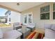 Covered patio area with plush seating and glass-topped wicker coffee table at 224 Gallant Fox Way, Acworth, GA 30102
