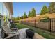 Relaxing backyard featuring a fire pit, small patio, and a black metal fence at 4565 Grenadine Cir, Acworth, GA 30101