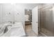 Bright bathroom featuring double sinks with white countertops, a walk-in shower, and neutral tile at 4565 Grenadine Cir, Acworth, GA 30101