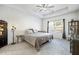Spacious bedroom with tray ceiling, carpeted floors, and ample natural light from a large window at 4565 Grenadine Cir, Acworth, GA 30101