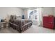 Bedroom with a large window and a red dresser, illuminated by natural light at 4565 Grenadine Cir, Acworth, GA 30101