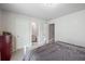 Neutral-colored bedroom with a grey bedspread, a window, and two doors at 4565 Grenadine Cir, Acworth, GA 30101