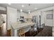 Modern kitchen with granite countertops, stainless steel appliances, and a central island for dining at 4565 Grenadine Cir, Acworth, GA 30101