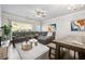 Cozy living room featuring a comfortable sectional sofa, large windows, and stylish decor at 4565 Grenadine Cir, Acworth, GA 30101