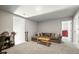 Carpeted living room with a couch, a table, a red dresser, and multiple doors at 4565 Grenadine Cir, Acworth, GA 30101