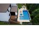 Aerial view of a backyard with a pool, hot tub, deck, patio, dining, and barbecue at 4976 Concert Ln, Marietta, GA 30066