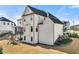Rear view of a home with a deck, covered patio, and backyard playset, with an expansive lawn at 4976 Concert Ln, Marietta, GA 30066