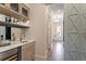 View of an elegant bar area with marble countertops, wine storage and custom cabinetry at 4976 Concert Ln, Marietta, GA 30066