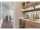 View of an elegant bar area with marble countertops, wine storage and custom cabinetry at 4976 Concert Ln, Marietta, GA 30066
