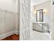 Bathroom featuring marble tile, modern vanity, and a glass-enclosed shower at 4976 Concert Ln, Marietta, GA 30066