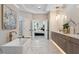 A modern bathroom boasts marble flooring, a freestanding tub, twin vanities, and an elegant entryway to the main bedroom at 4976 Concert Ln, Marietta, GA 30066