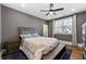 A well-lit bedroom includes a ceiling fan, neutral decor, light-blocking curtains, and comfortable furnishings at 4976 Concert Ln, Marietta, GA 30066