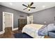 A well-lit bedroom includes a ceiling fan, neutral decor, light-blocking curtains, and an adjacent walk-in closet at 4976 Concert Ln, Marietta, GA 30066