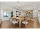 Open dining area featuring a wooden table, modern light fixture, and a view into the kitchen at 4976 Concert Ln, Marietta, GA 30066