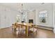 Elegant dining room with a wooden table, stylish chairs, and large windows overlooking greenery at 4976 Concert Ln, Marietta, GA 30066
