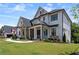 Beautiful two-story home featuring a stone and white brick facade, manicured lawn, and inviting front porch at 4976 Concert Ln, Marietta, GA 30066
