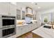Bright and airy kitchen with white cabinetry, stainless steel appliances, and a spacious countertop at 4976 Concert Ln, Marietta, GA 30066