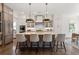 Open kitchen featuring an island with seating, pendant lighting, and stainless steel appliances at 4976 Concert Ln, Marietta, GA 30066
