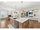 Expansive kitchen featuring a large island, stainless steel appliances, and a view into the living space at 4976 Concert Ln, Marietta, GA 30066
