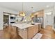 Open kitchen with large island, pendant lighting, stainless steel appliances, and view of the living area at 4976 Concert Ln, Marietta, GA 30066