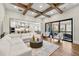 Spacious living room with beamed ceilings, a comfortable white sofa, and large windows at 4976 Concert Ln, Marietta, GA 30066