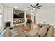 Cozy living room with hardwood floors, ceiling fan, built-in bar, and large leather sofa at 4976 Concert Ln, Marietta, GA 30066