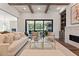 View of a bright and airy living room with hardwood floors and a view to the patio and fireplace at 4976 Concert Ln, Marietta, GA 30066