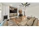 Cozy living room with a large sofa, ceiling fan, and rustic wall decor above the TV at 4976 Concert Ln, Marietta, GA 30066