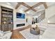 Spacious living room with coffered ceiling, fireplace, hardwood floors, and open staircase at 4976 Concert Ln, Marietta, GA 30066